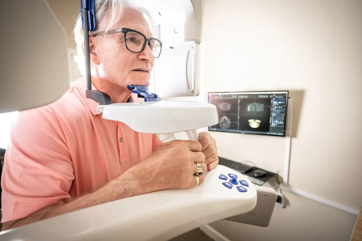 A patient receiving a 3D CBCT scan at Beyond Exceptional Dentistry
