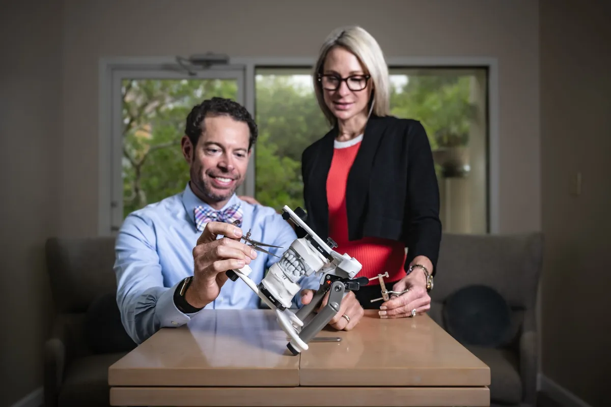 Dr. Ryan Reeves and a team member studying a patient's dental articulator model