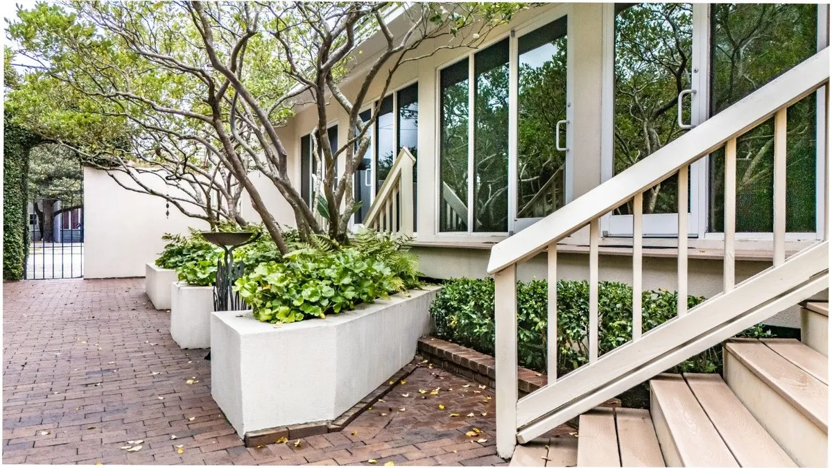 The planted courtyard entrance of Beyond Exceptional Dentistry in Savannah