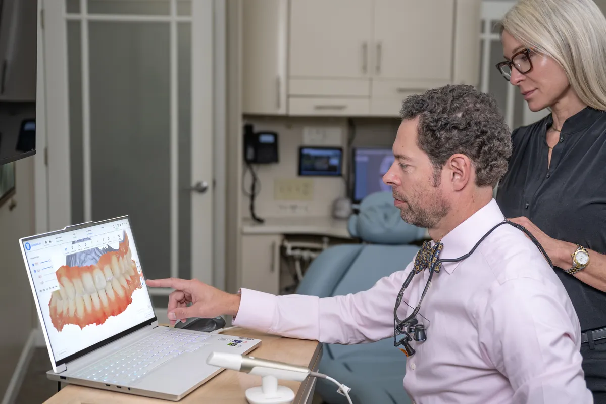 Dr. Ryan Reeves showing a patient her 3D smile scan on screen